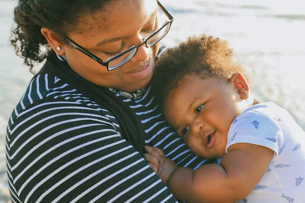 woman holding happy baby