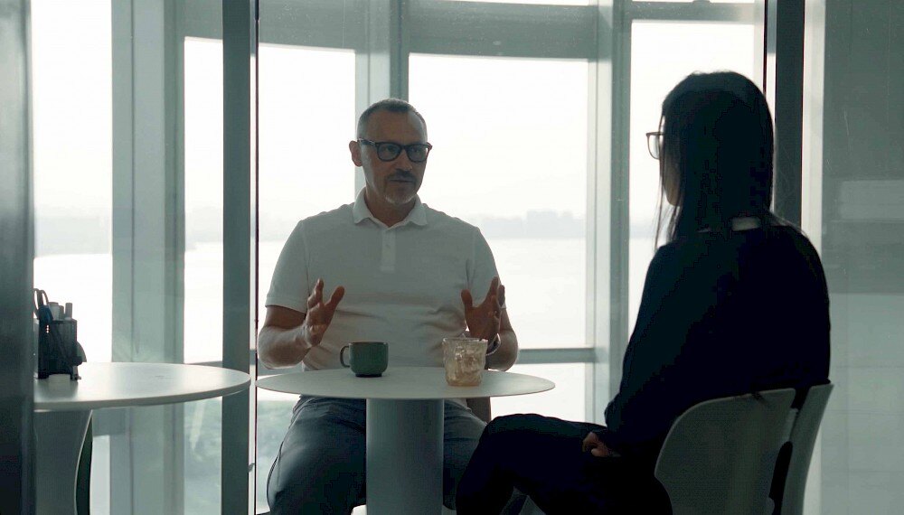 man chatting to woman around table