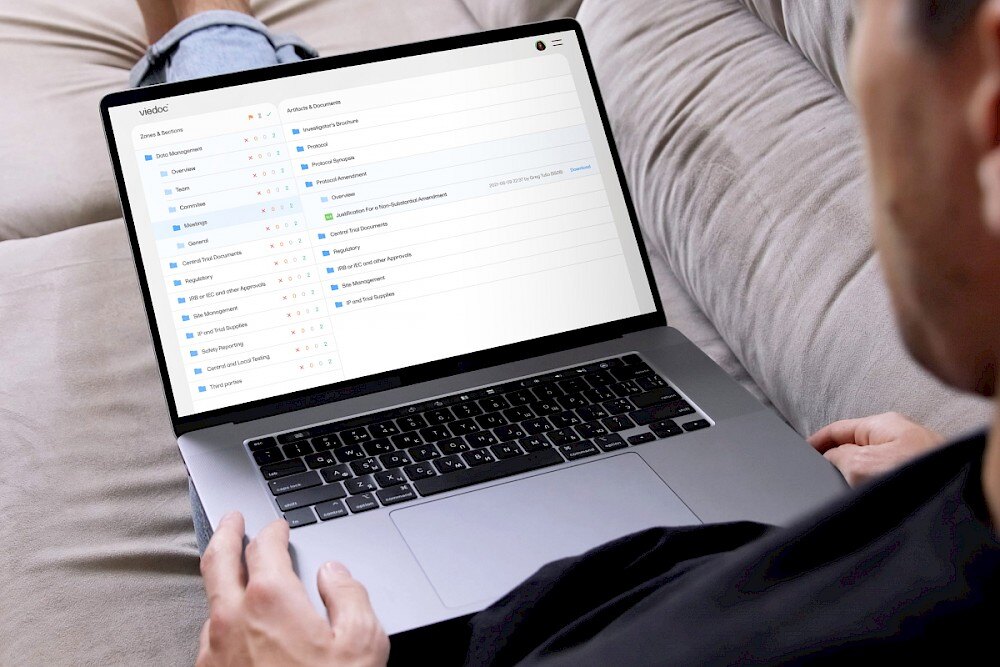 man looking at viedoc software on sofa