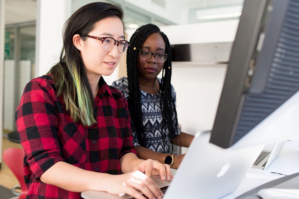 two women looking at computer screen