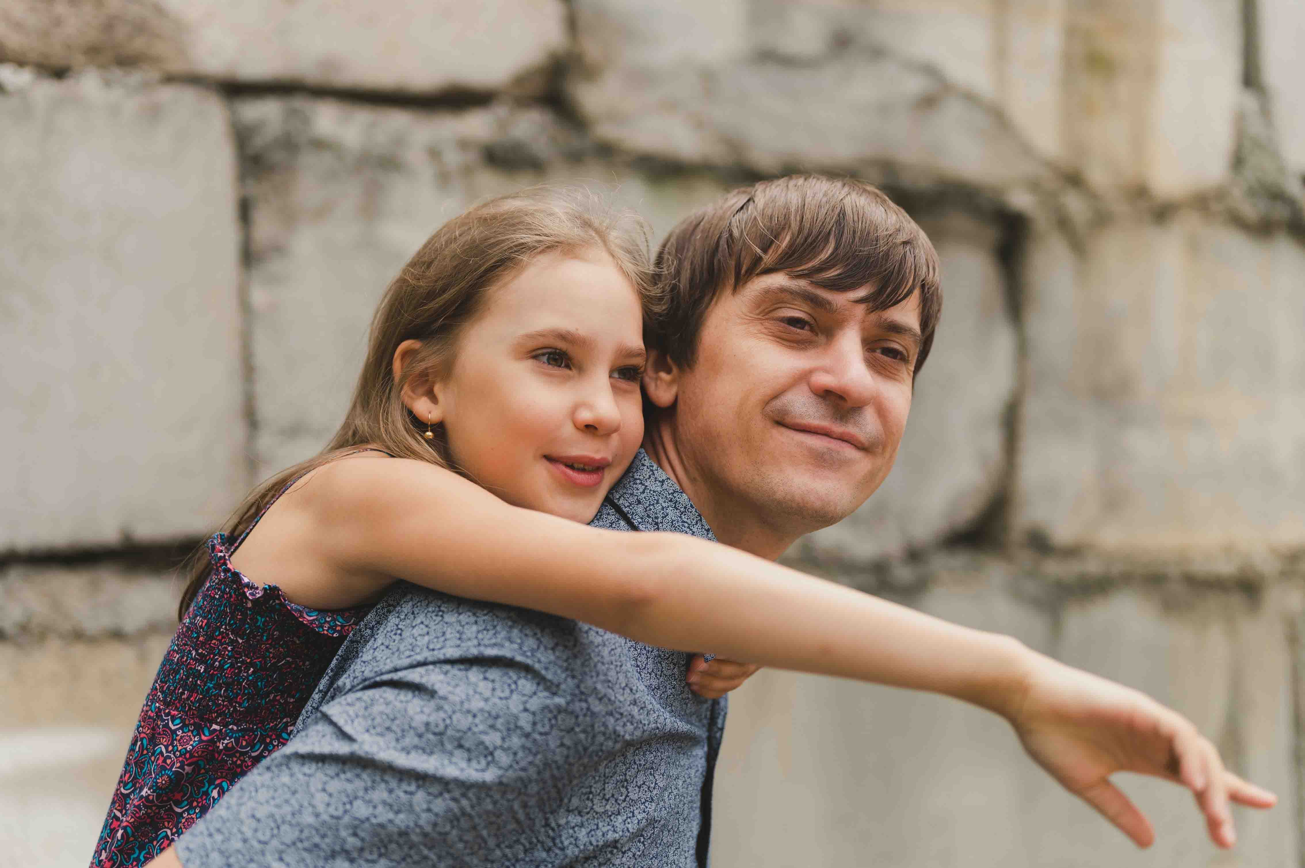 smiling man with child on back