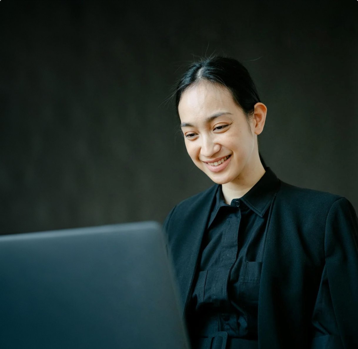 woman-smiling-working-on-a-computer