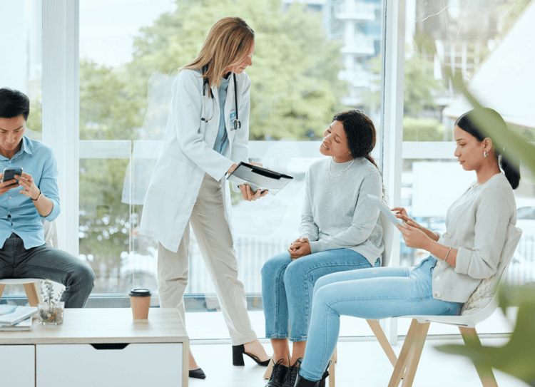 Doctor talks to patient in clinical trial waiting room