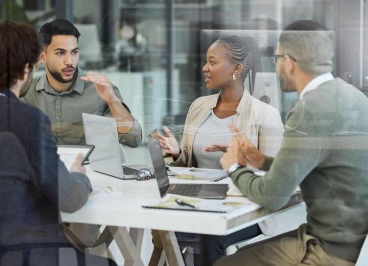 Team collaborating in a meeting, illustrating CTC and Dicot Pharma managing multi-site clinical trials with Viedoc