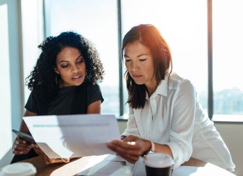 two-professional-women-reviewing-documents