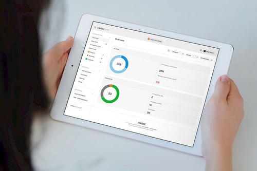 A device showing Viedoc’s TMF product, with someone viewing it from behind, demonstrating its use in managing clinical trial documents.