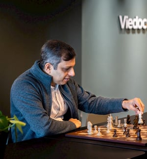 Binish Peter, Technical Fellow at Viedoc, playing chess, focused on the game.