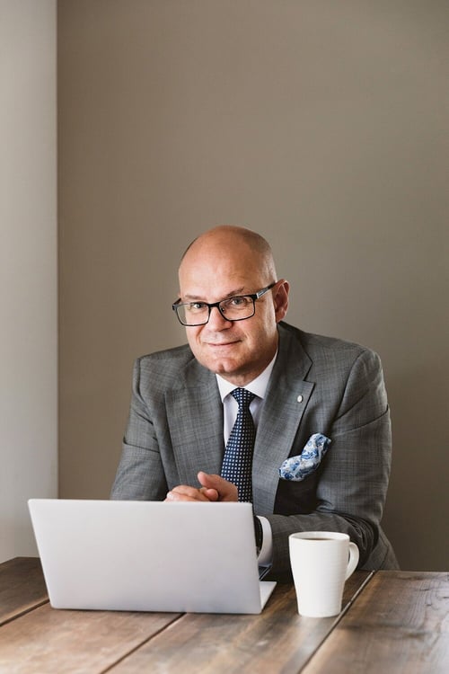 Sverre Bengtsson, Co-Founder of Viedoc, sitting at a desk in front of a computer looking into the camera, representing the thoughtful and focused approach needed for analyzing real-world data and overcoming challenges like biases and confounding factors.