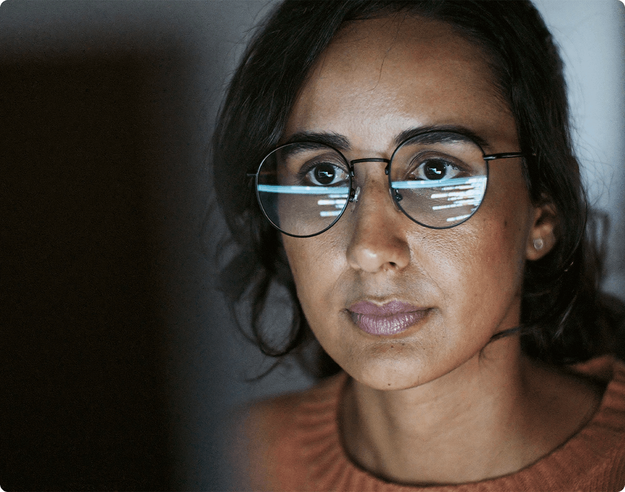 woman looking at monitor in dark room