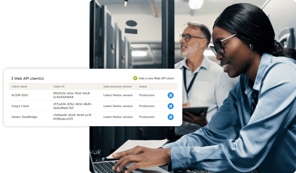 woman typing on laptop with man in background using tablet with API UI