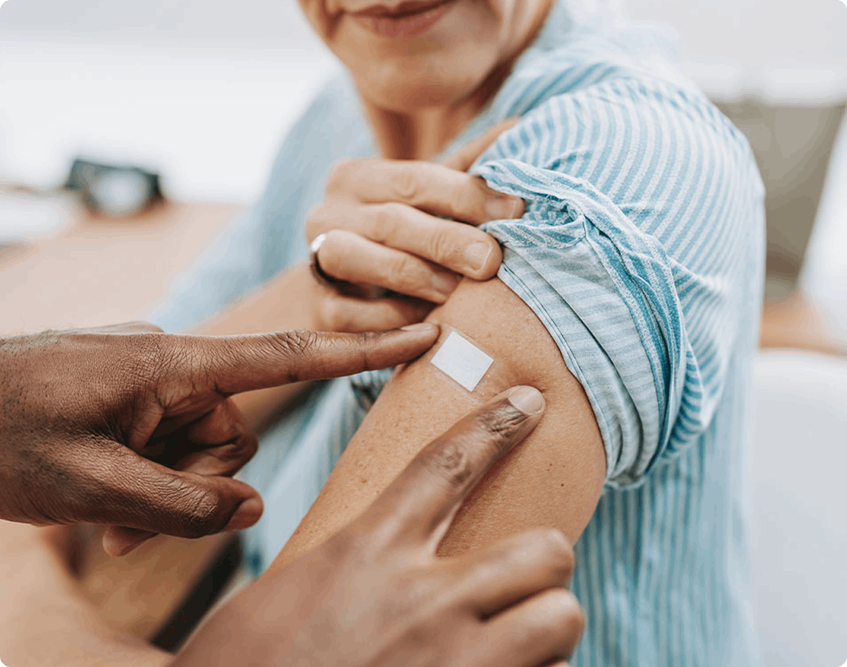 woman having a plaster placed on her upper arm