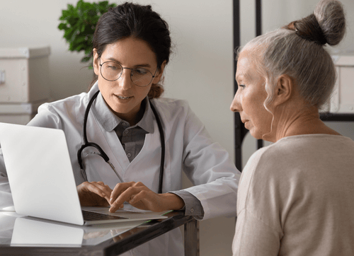 Doctor and patient looking at laptop