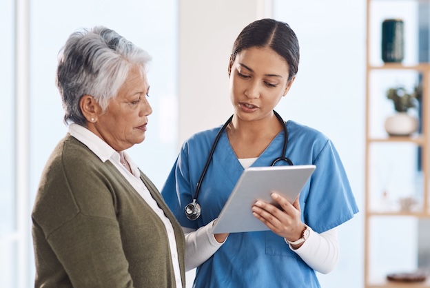 Medical professional talks patient through clinical trial
